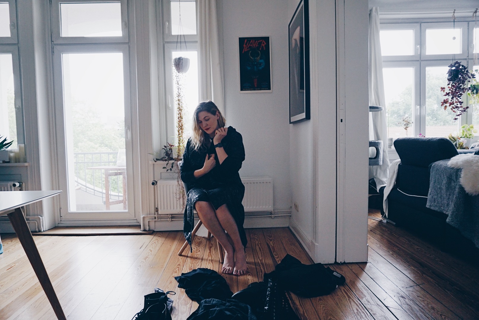 young women sitting on a chair in male clothes