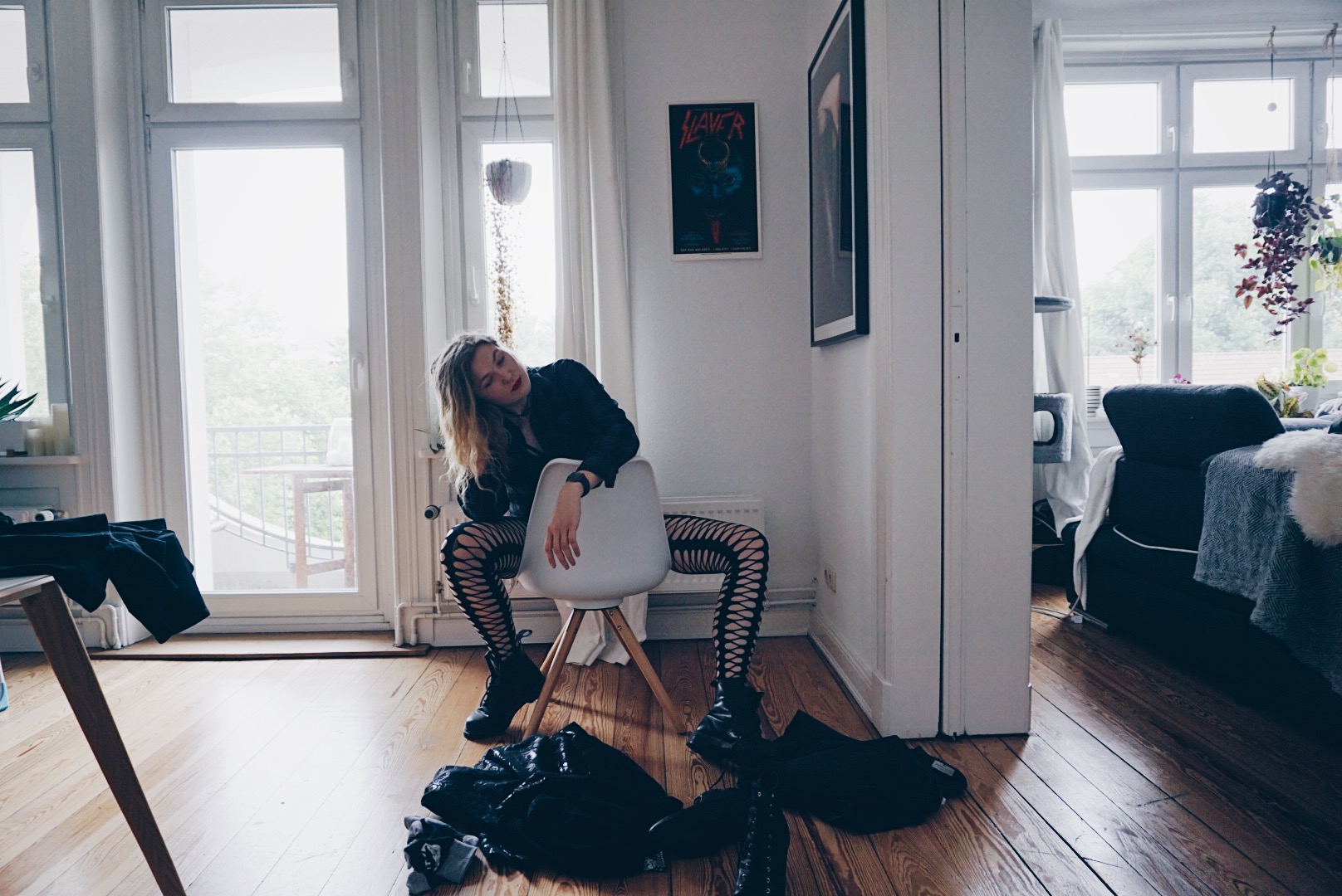 young women sitting on a chair in male clothes